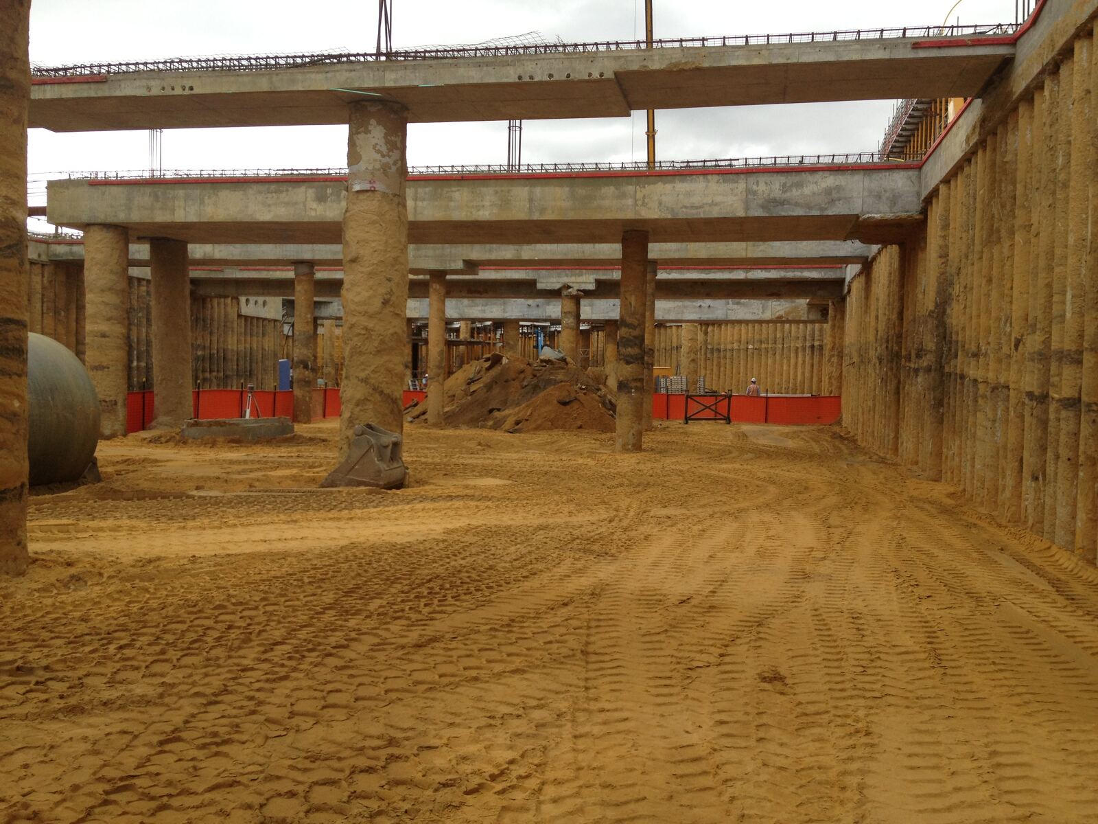 Loader working between the columns of a basement car park dig
